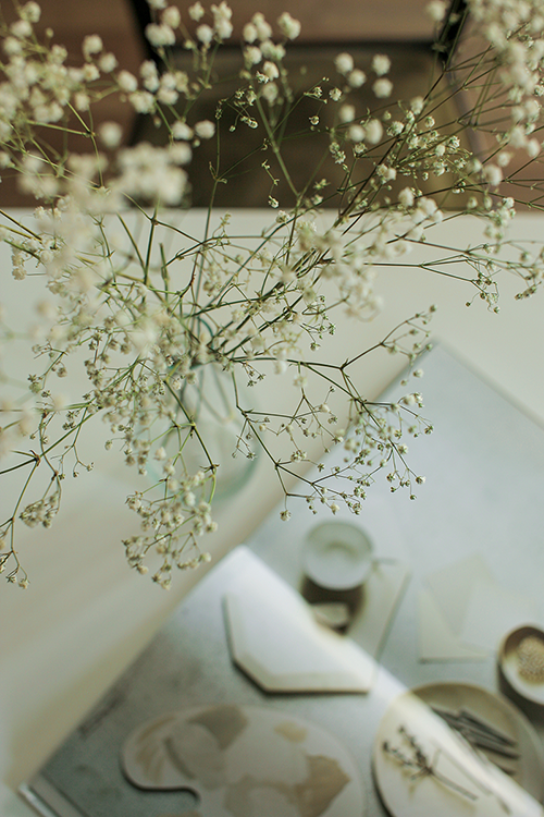 Open interior album lying on table surrounded by flowers